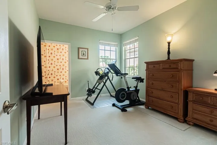 Bathroom featuring double vanity, tile patterned floors, a shower with shower door, and ornamental molding