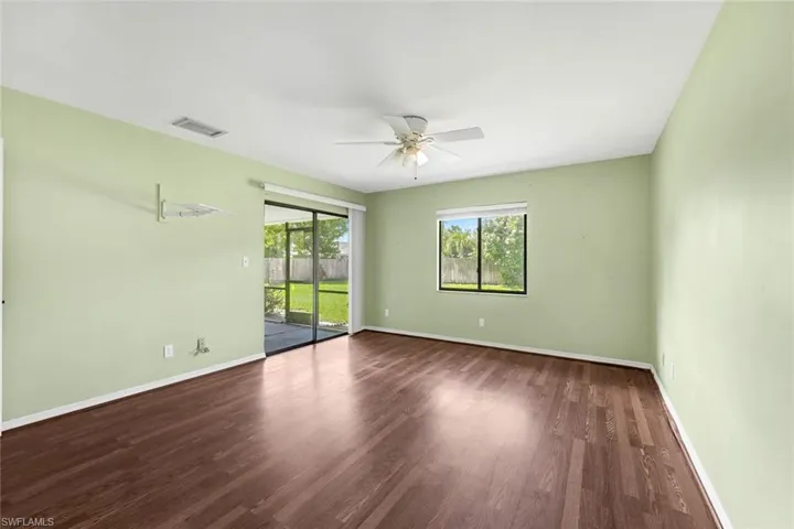 Unfurnished room with ceiling fan and wood-type flooring