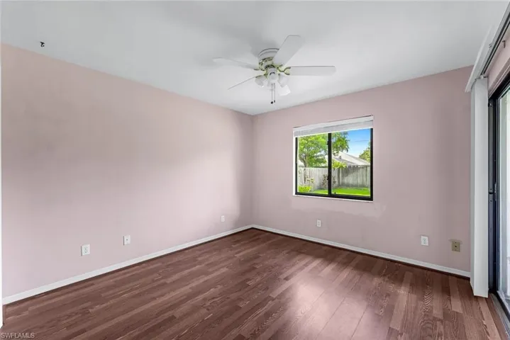 Spare room with dark hardwood / wood-style floors and ceiling fan