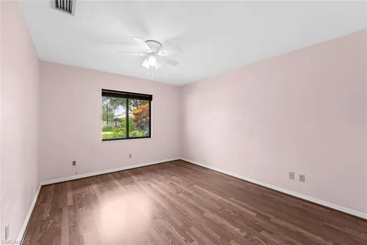 Unfurnished room featuring wood-type flooring and ceiling fan