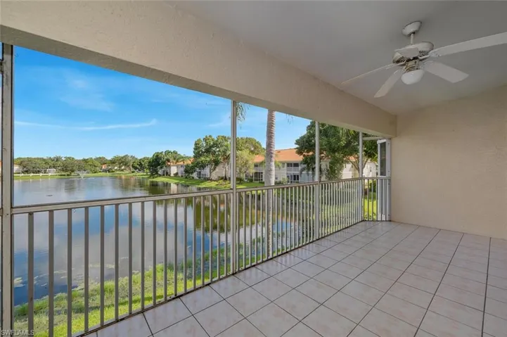 Unfurnished sunroom with a water view and ceiling fan