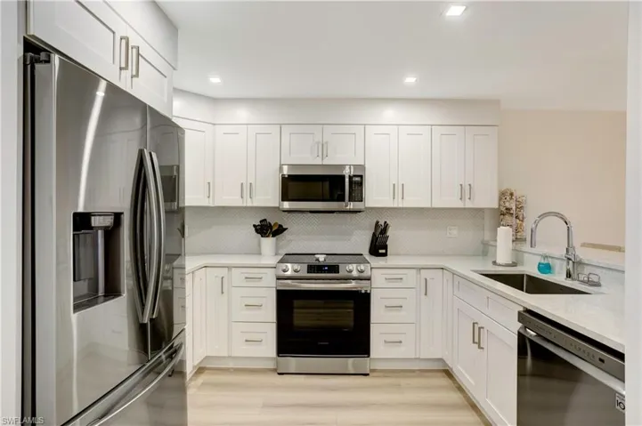 Custom Tile Backsplash, Stainless Appliances including Counter Depth French Door Refrigerator.