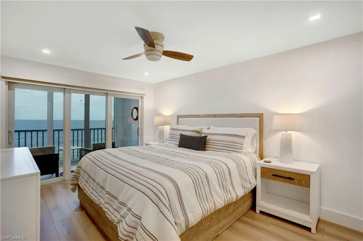 Spacious Primary Bedroom with sliders out to the Balcony-electric custom shades.