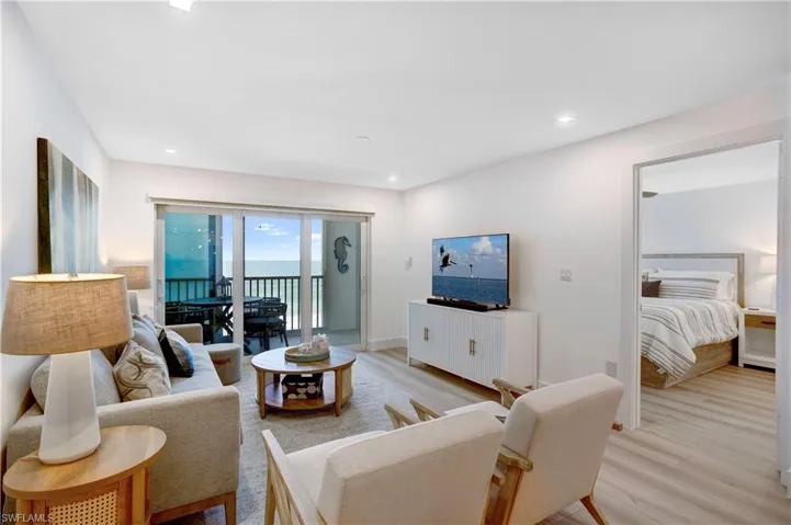Open Floor Plan with views of the Gulf of Mexico with impact doors on interior & exterior balcony!