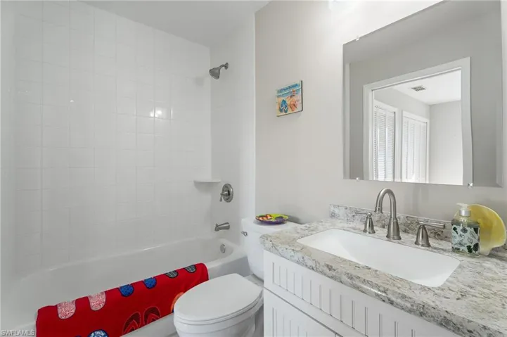Full Guest bath with bathing tub / shower combination, and vanity.