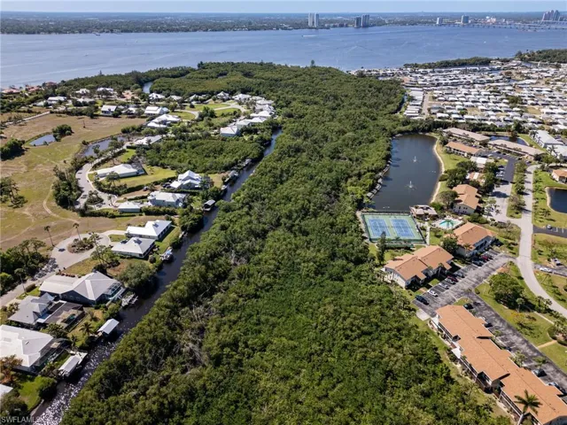Birds eye view of property featuring a water view and a residential view.