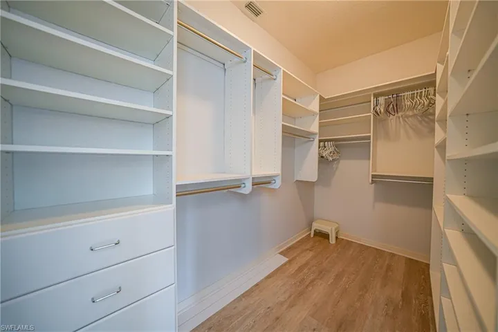 Spacious closet featuring light hardwood / wood-style flooring