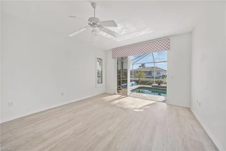 Unfurnished room with ceiling fan and light hardwood / wood-style flooring