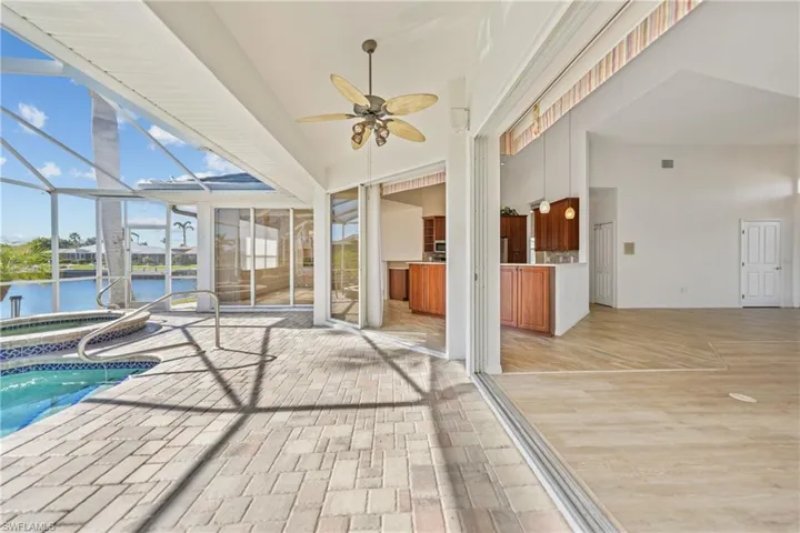 View of pool featuring ceiling fan and a water view