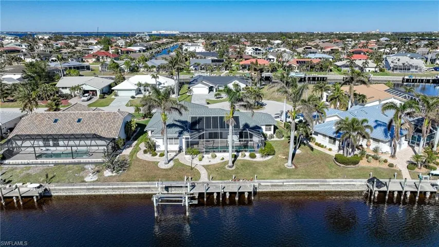 Birds eye view of property with a water view