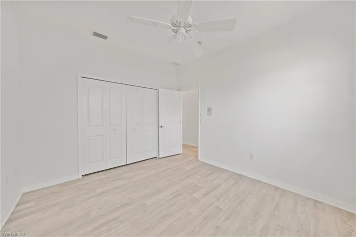 Unfurnished bedroom with ceiling fan, a closet, and light hardwood / wood-style floors