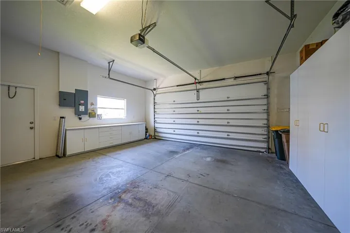 Garage with electric panel and a garage door opener
