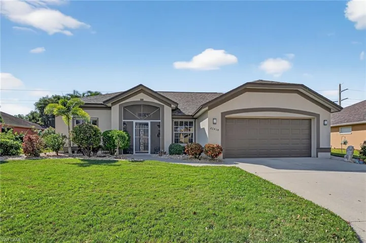Ranch-style home featuring stucco siding, a front lawn, concrete driveway, a garage, and a shingled roof