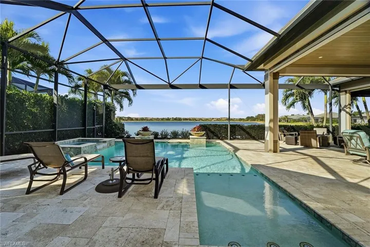 View of swimming pool featuring a lanai, a water view, a sunroom, and a patio area