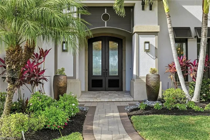 View of exterior entry with french doors and stucco siding