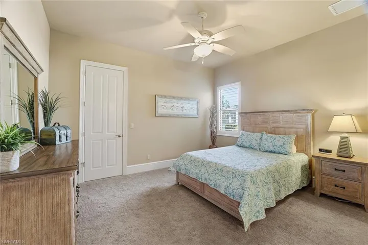 Bedroom with light carpet and ceiling fan