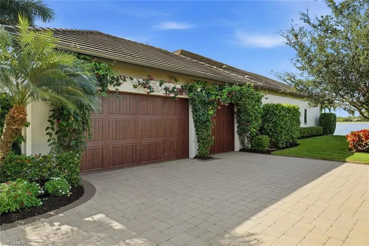 Garage featuring decorative driveway
