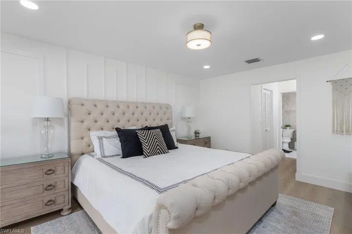 Bedroom featuring baseboards, visible vents, recessed lighting, and wood finished floors