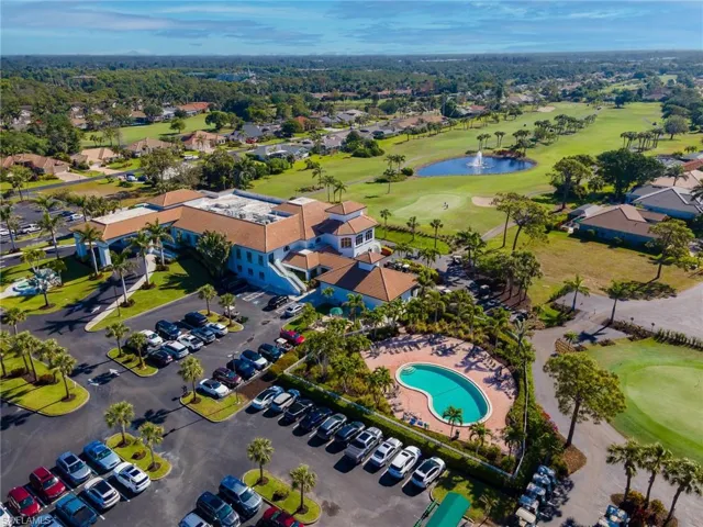 Birds eye view of property with golf course view and a water view