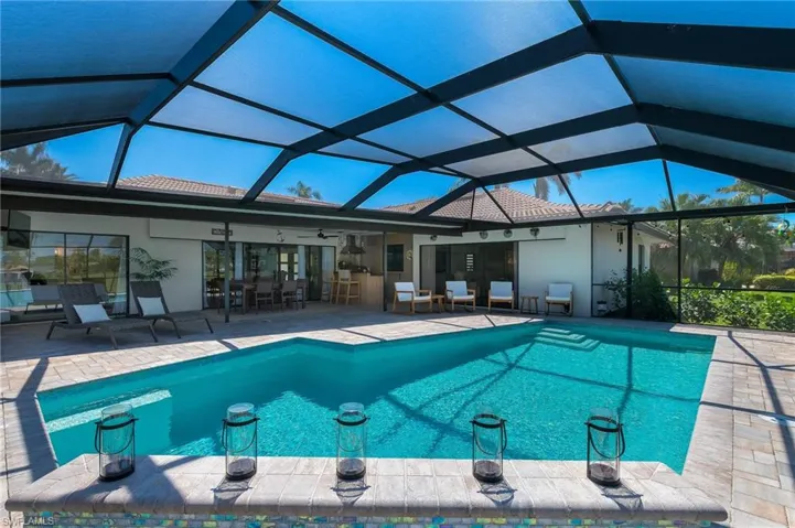 Pool with a ceiling fan, a lanai, and a patio area