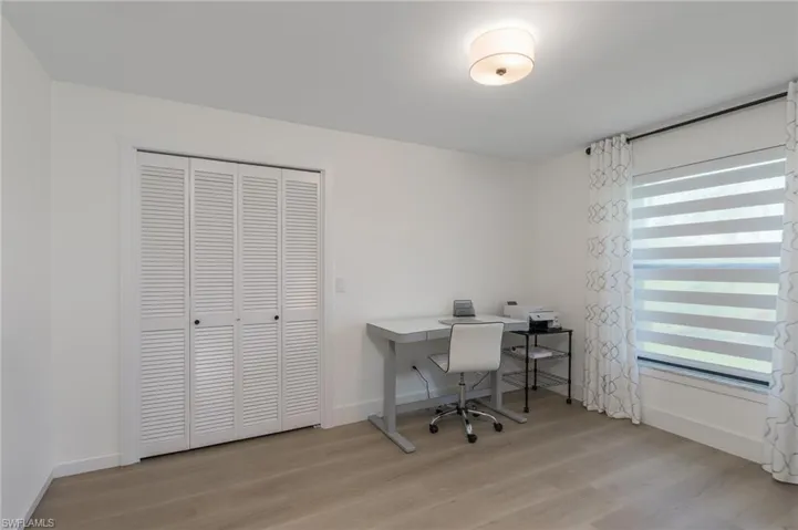 Office area featuring light wood finished floors and baseboards
