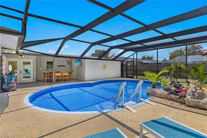 Lots of space around the pool in the oversized screened in lanai pool enclosure.  New vinyl pool liner in 2023.  Amazing concrete pool deck designed to be slip resistant and look like a sandy beach!