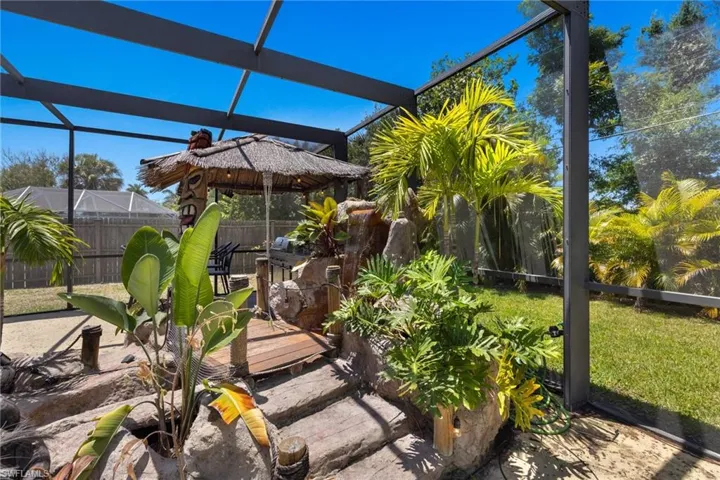 Enjoy the tropical island vibe steps and wooden bridge over the stream from the waterfall!
