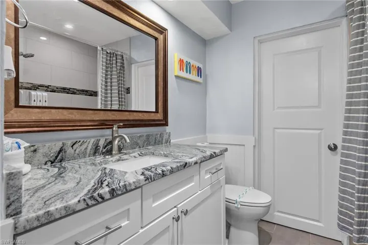 Guest bathroom with new matching cabinets and granite counters.