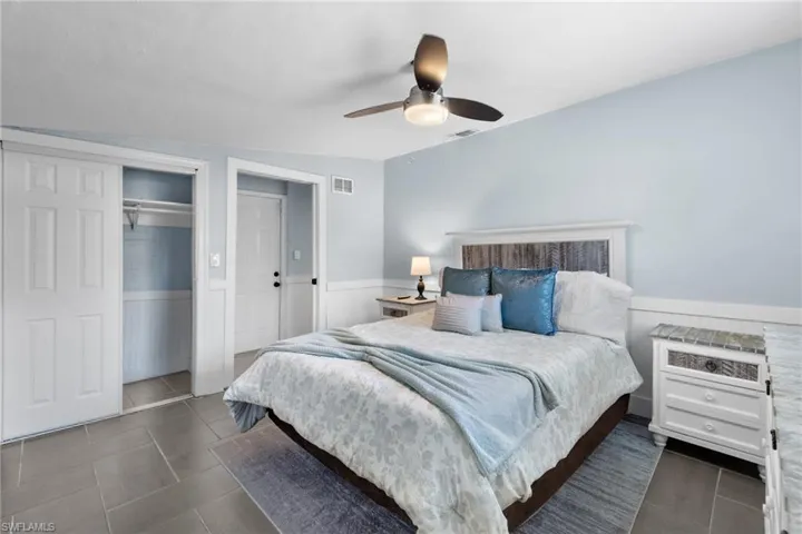 Guest bedroom 4 with wide closet and hallway door access to the pool area.  Queen size bed.