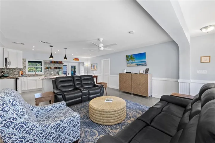 The living room with patterned tile and open kitchen with island counter makes for a great entertaining space!