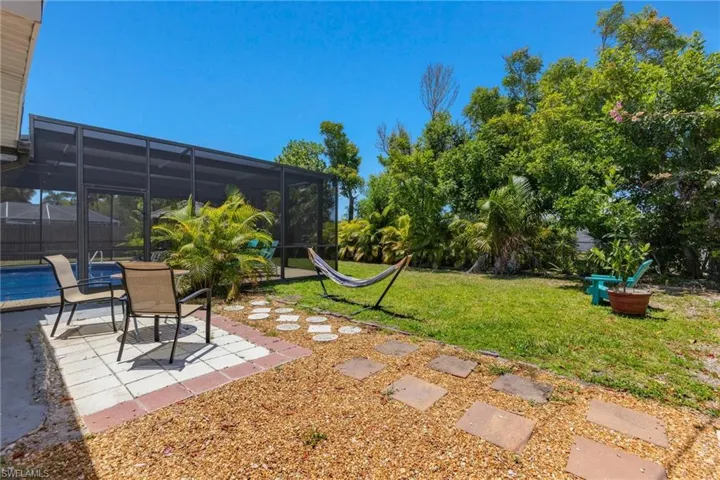 That patio next to the pool enclosure is great for relaxing in the direct sun.