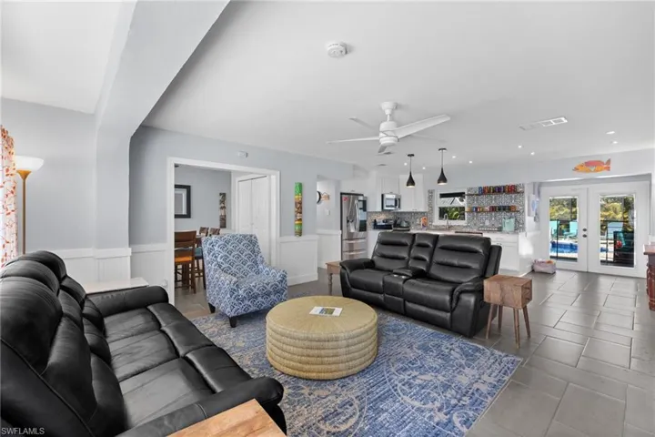 Open living room and kitchen offer a great entertaining space with new tile throughout the home.