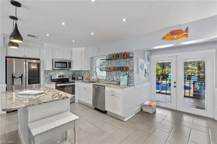 Fully renovated interior with new kitchen, appliances, white cabinets, and granite countertops.