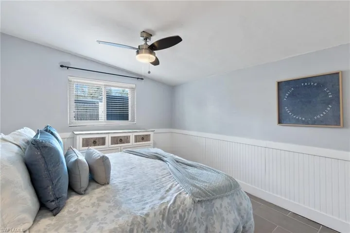 Guest bedroom 4 with impact windows and queen sized bed.