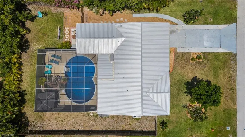 New metal roof installed in 2022.  Notice the extra amount of space under the screened in lanai which is rare to find in pool homes!