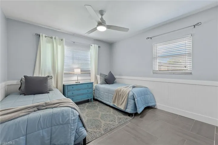Guest bedroom 3 with two single beds and 2 impact windows.