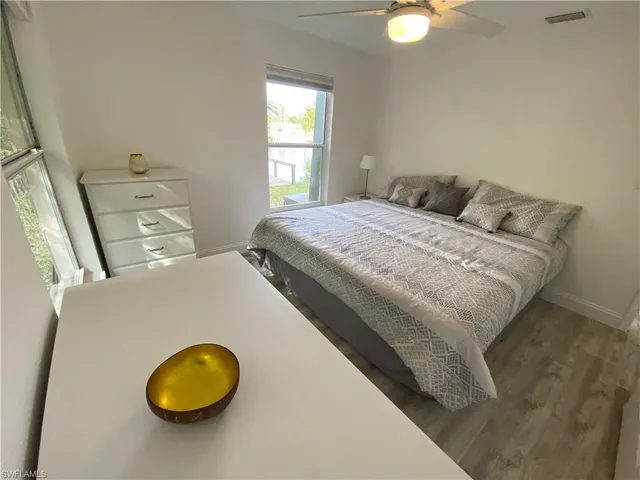 Bedroom featuring wood finished floors and a ceiling fan