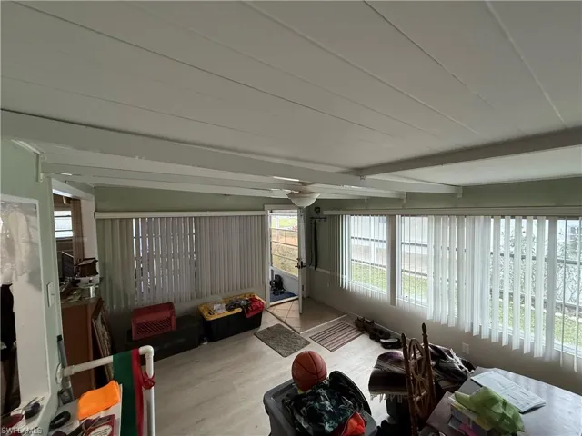 Sunroom / solarium featuring beamed ceiling