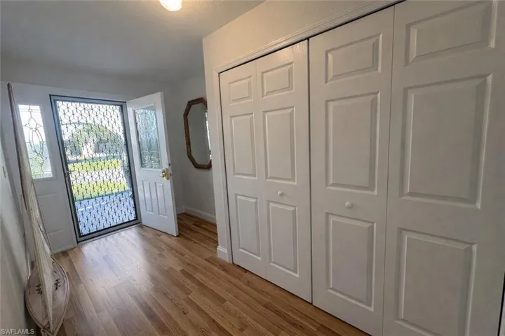 Foyer with baseboards and light wood-type flooring