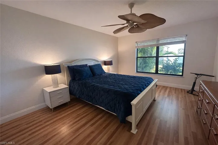 Bedroom featuring dark wood-type flooring and ceiling fan