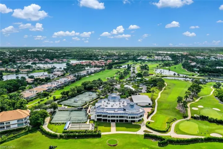 Aerial perspective of suburban area with a golf club and a nearby body of water