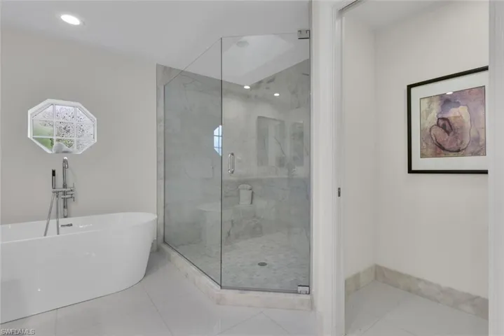 Full bath with a soaking tub, a marble finish shower, tile patterned floors, and recessed lighting