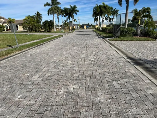 View of street with curbs and Court and community building on the right.