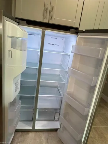 Kitchen view of freestanding refrigerator