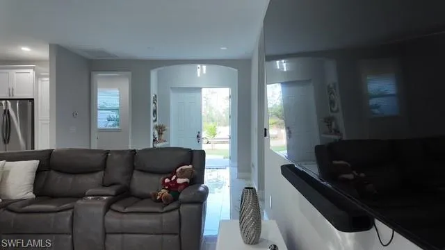 Tiled living room with recessed lighting