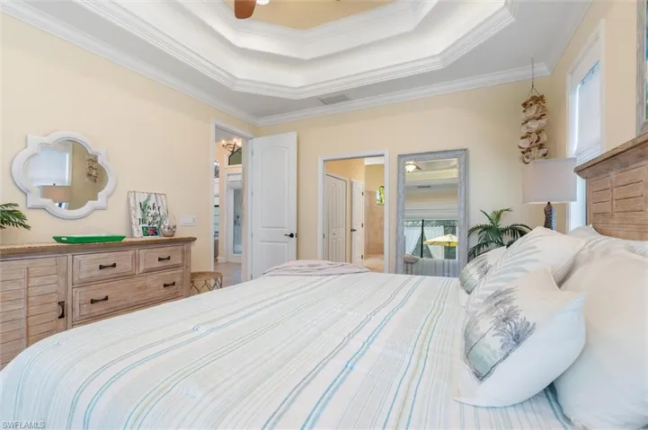 Bedroom featuring a raised ceiling and ornamental molding