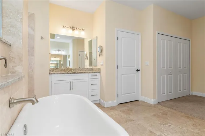 Bathroom with a tub to relax in and vanity