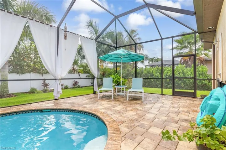 View of swimming pool with a lanai and a patio area