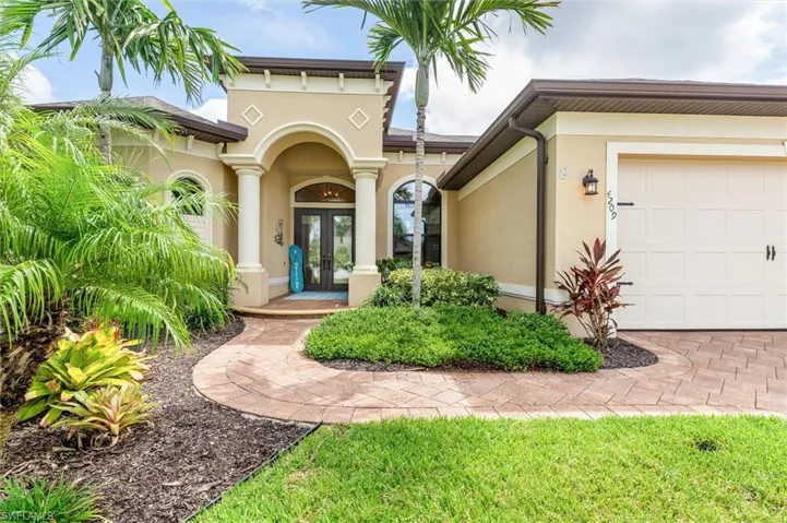 Entrance to property with a garage and french doors