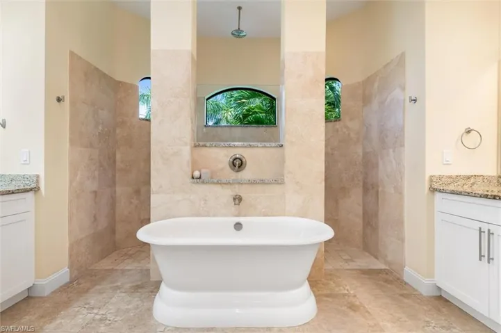 Bathroom with vanity and shower with separate bathtub